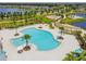 Resort style zero entry community pool with splash pad, playground, walking trail, and lake views at 11407 Drifting Leaf Dr, Riverview, FL 33579