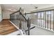 Staircase with wood handrails and decorative iron balusters leading to the second-floor landing at 11407 Drifting Leaf Dr, Riverview, FL 33579