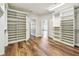 Expansive walk-in closet with ample shelving, custom cabinetry and open doorways at 11407 Drifting Leaf Dr, Riverview, FL 33579