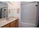 Clean bathroom featuring a vanity, mirror, shower, and bathtub at 11623 Greensleeve Ave, Tampa, FL 33626