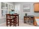 Bright breakfast nook with shutters, art, a table, and dual wine fridges at 11623 Greensleeve Ave, Tampa, FL 33626