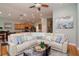 Spacious living room with a large sectional sofa, open layout, and a view of the kitchen at 11623 Greensleeve Ave, Tampa, FL 33626
