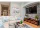 Comfortable living room showcasing a stone accent wall, plush sofa, and stylish decor at 11623 Greensleeve Ave, Tampa, FL 33626