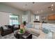Bright and airy living room with sliding glass doors, comfortable seating, and views of the pool area at 11623 Greensleeve Ave, Tampa, FL 33626