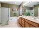 Main bathroom featuring a glass enclosed shower, soaking tub, double sink vanity, and neutral tones at 11623 Greensleeve Ave, Tampa, FL 33626