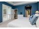 Main bedroom showcasing a trey ceiling, cool blue walls, and a glimpse of the ensuite bathroom at 11623 Greensleeve Ave, Tampa, FL 33626