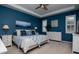 Serene main bedroom featuring blue walls, tray ceiling, and white plantation shutters for natural light at 11623 Greensleeve Ave, Tampa, FL 33626