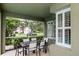 Covered patio with comfortable seating and views of the surrounding neighborhood at 11623 Greensleeve Ave, Tampa, FL 33626