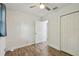 Bright bedroom with wood-look flooring, ceiling fan, and closet, offering a comfortable retreat at 1311 W Perdiz St, Tampa, FL 33612