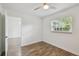 Bright bedroom features wood-look floors, natural light, and seamless access to a connected living area at 1311 W Perdiz St, Tampa, FL 33612