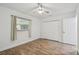 Bedroom features wood-look floors, natural light, a ceiling fan, and closet space at 1311 W Perdiz St, Tampa, FL 33612