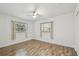 Bedroom featuring wood-look floors, natural light, and a ceiling fan at 1311 W Perdiz St, Tampa, FL 33612