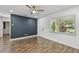 Spacious bedroom with modern wall accent, natural light, and wood-look floors at 1311 W Perdiz St, Tampa, FL 33612