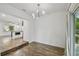 Open dining room with wood floors, modern lighting, and seamless access to outdoor spaces at 1311 W Perdiz St, Tampa, FL 33612