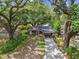 Charming home with carport under the shade of mature trees, featuring a well-maintained front yard at 1311 W Perdiz St, Tampa, FL 33612