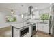 Modern kitchen with stainless steel appliances, granite countertops, and ample cabinet space at 1311 W Perdiz St, Tampa, FL 33612