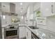 Modern kitchen design with stainless steel appliances, granite countertops, and a stylish faucet at 1311 W Perdiz St, Tampa, FL 33612