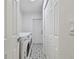 Bright laundry room with white washer and dryer, patterned tile floors, and ample closet space at 1311 W Perdiz St, Tampa, FL 33612