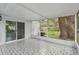 Enclosed porch with decorative tile flooring, offering a serene space connected to the outdoors at 1311 W Perdiz St, Tampa, FL 33612