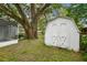 Backyard shed under a mature shade tree near the enclosed porch at 1311 W Perdiz St, Tampa, FL 33612