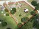 Aerial view of a large property with multiple structures outlined in red on a sunny day at 13330 Fort King Rd, Dade City, FL 33525