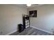 Small bedroom featuring a storage unit, gray walls, and gray wood-look floors at 13330 Fort King Rd, Dade City, FL 33525