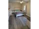 Cozy bedroom features modern vinyl flooring, a full bed, and matching nightstands at 13330 Fort King Rd, Dade City, FL 33525