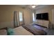 Relaxing bedroom with a comfortable bed, gray vinyl flooring, and bright natural light at 13330 Fort King Rd, Dade City, FL 33525