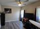 Cozy bedroom with ceiling fan and hardwood flooring at 13330 Fort King Rd, Dade City, FL 33525