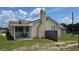 Charming home exterior featuring a brick chimney, inviting porch area, and a well-maintained yard at 13330 Fort King Rd, Dade City, FL 33525