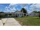 Charming single-story home featuring a front yard, covered parking, and lovely curb appeal at 13330 Fort King Rd, Dade City, FL 33525