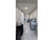 Hallway featuring a grill and tile flooring, offering a glimpse into the home's interior at 13330 Fort King Rd, Dade City, FL 33525