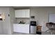 Efficient kitchenette equipped with cabinets, sink, and compact appliances at 13330 Fort King Rd, Dade City, FL 33525