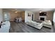 Open-concept living and dining area with modern vinyl flooring and a decorative fireplace at 13330 Fort King Rd, Dade City, FL 33525