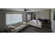 Spacious living room featuring comfortable sofas, a ceiling fan, and bright windows at 13330 Fort King Rd, Dade City, FL 33525