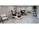 Large studio space with tiled floors, a massage chair, work stations, and neutral walls at 13330 Fort King Rd, Dade City, FL 33525