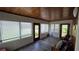 Bright sunroom with ample windows, wood ceiling, and vinyl flooring at 13330 Fort King Rd, Dade City, FL 33525