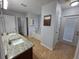 Bright bathroom with double sinks, granite countertop, soaking tub, and backyard access at 13551 Banner Rd, Spring Hill, FL 34609