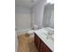Clean bathroom includes tub, shower, and single sink vanity at 13551 Banner Rd, Spring Hill, FL 34609