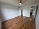 Spacious bedroom features wood floors, ceiling fan, and access to bathroom at 13551 Banner Rd, Spring Hill, FL 34609