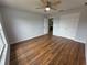 Bedroom with wood floors features ceiling fan and double door closet at 13551 Banner Rd, Spring Hill, FL 34609