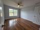 Bedroom featuring wood flooring, neutral paint, lots of natural light, and ceiling fan at 13551 Banner Rd, Spring Hill, FL 34609