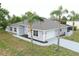 Lovely single-story home boasts a two-car garage and meticulous landscaping with vibrant palm trees at 13551 Banner Rd, Spring Hill, FL 34609