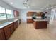 Kitchen with stainless steel appliances, wood cabinets, granite counters and kitchen island at 13551 Banner Rd, Spring Hill, FL 34609