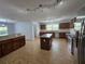 Spacious kitchen area with stainless steel appliances, granite countertops, and an island at 13551 Banner Rd, Spring Hill, FL 34609