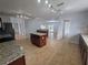 Open-concept kitchen featuring a large island, stainless appliances, and ample cabinet space at 13551 Banner Rd, Spring Hill, FL 34609