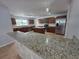 Well-equipped kitchen with stainless steel appliances, granite countertops, and a functional center island at 13551 Banner Rd, Spring Hill, FL 34609