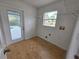 The laundry room has tile floors, a window, and a door that leads to the pool at 13551 Banner Rd, Spring Hill, FL 34609