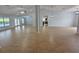 Expansive living room with wood-look tile, ceiling fan and views of the pool at 13551 Banner Rd, Spring Hill, FL 34609