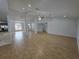 Expansive living area with modern lighting and flows into the dining and kitchen areas at 13551 Banner Rd, Spring Hill, FL 34609
